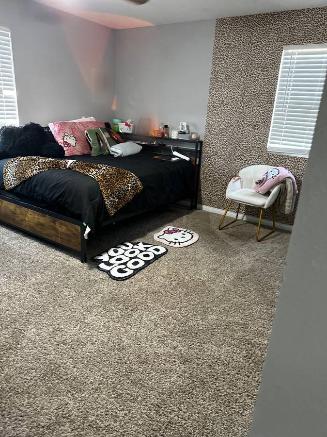 The same bedroom after cleaning, bed made and floor clear